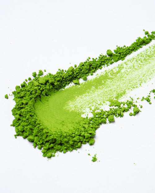 High-quality Uji matcha powder in bright green color, displayed on clean white background.